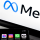 The Meta Logo on a laptop screen while a phone displays the app icons for Facebook, Instagram, WhatsApp and Oculus